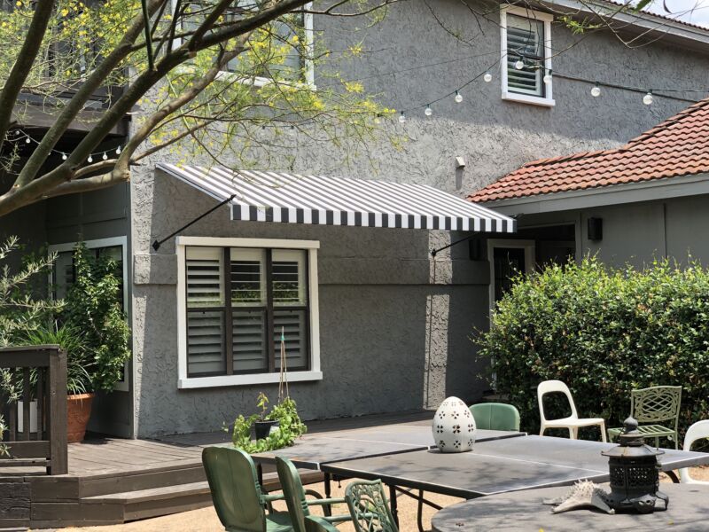 Open wing fabric awning with spear supports Austin American Awning